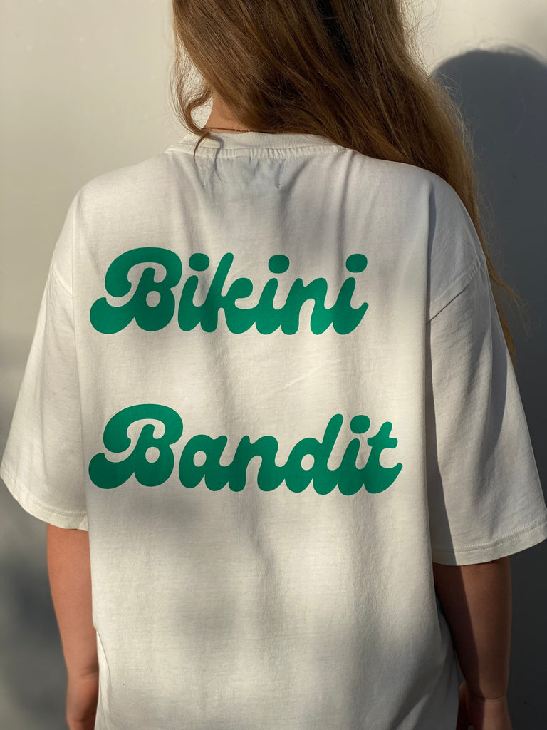 Oversized Bikini Bandit slogan T-shirt in cream with green font.