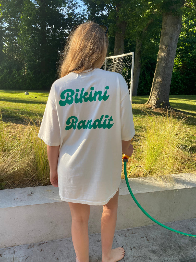 Oversized Bikini Bandit slogan T-shirt in cream with green font.